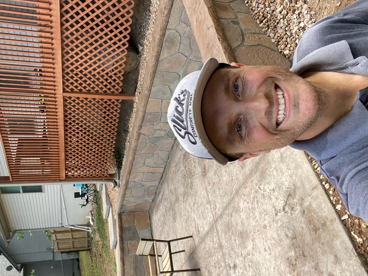 Keyan smiling at a completed residential concrete project