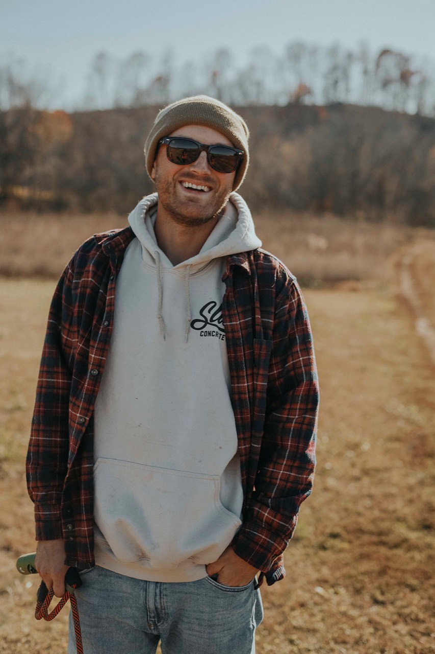 Keyan Lunders smiling outdoors in Northwest Arkansas