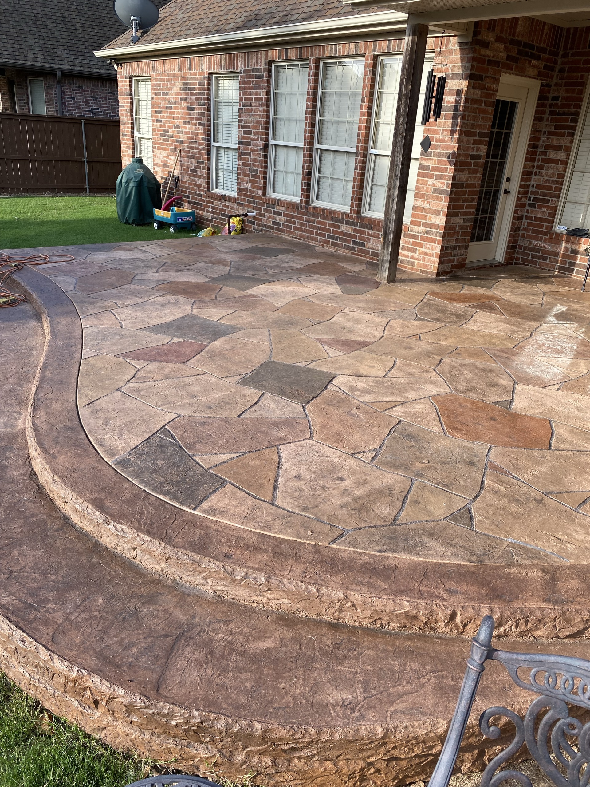 A finished earth-tone stamped concrete patio