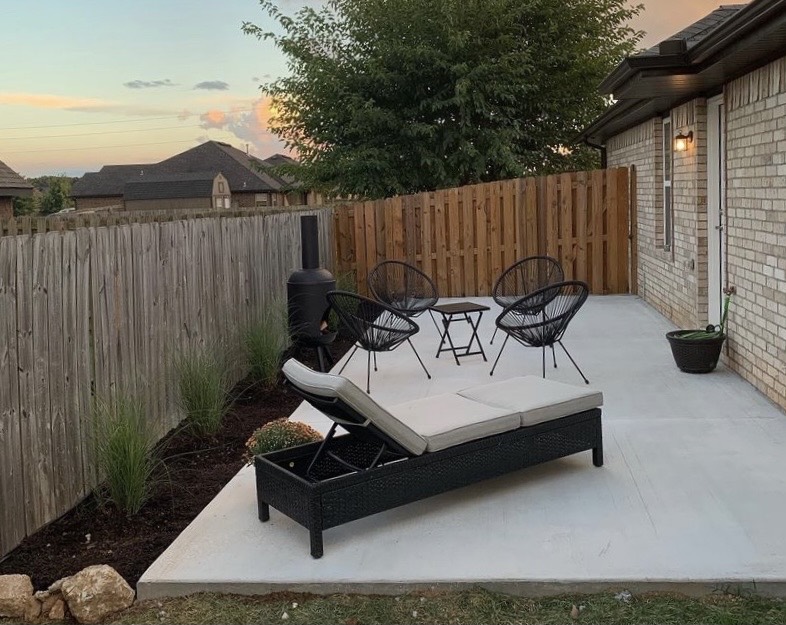 A finished plain concrete patio furnished as an outdoor living space